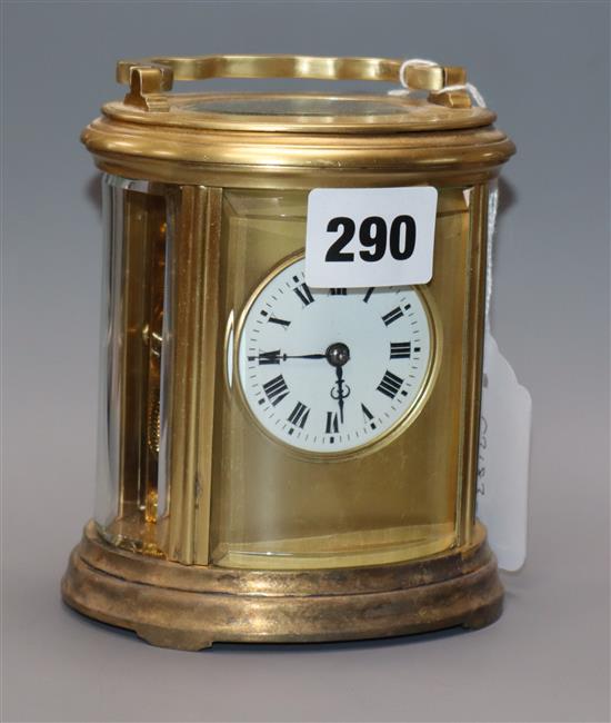 An Edwardian oval brass carriage clock, with travelling case height 13cm